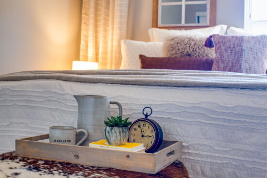 A Table in Front of the Bed With a Tray
